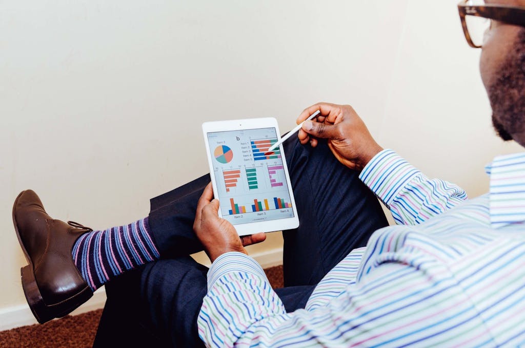 Businessman using a tablet for data analysis in a relaxed office setting.